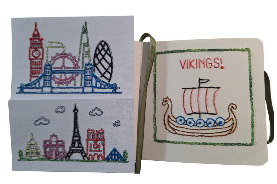 Image of an open book with stitched pictures - paris skyline, london skyline and a viking ship